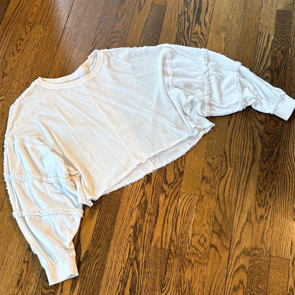 Free People Movement Cropped White Raw-Edge top Ruffle sleeve detail, M